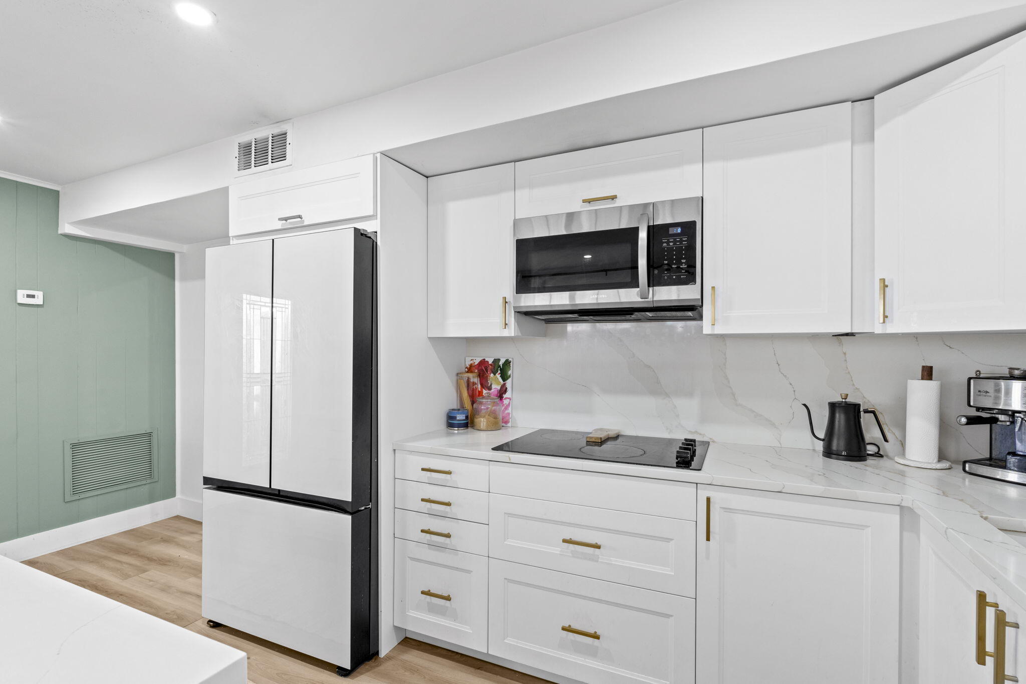 715 Kaye Street West Palm Beach, FL 33405 - Photo 19 of 40 a kitchen with stainless steel appliances white cabinets and a refrigerator