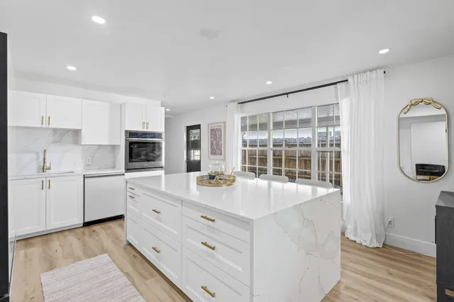a kitchen with a sink a stove and cabinets
