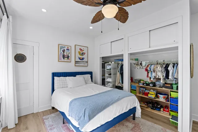 a bedroom with a bed and a book shelf