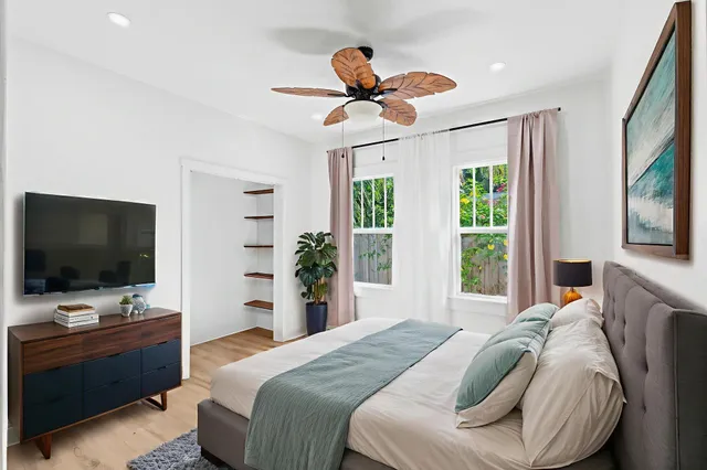 a bedroom with a bed and a flat screen tv