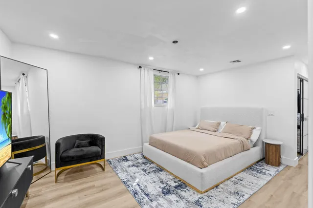 a bedroom with a bed and a dresser