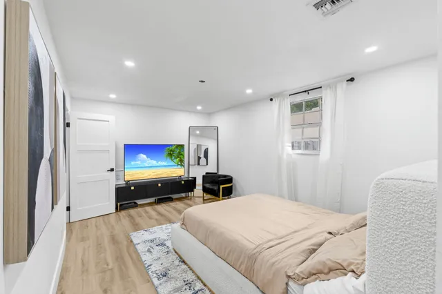 a bedroom with a bed and a flat screen tv