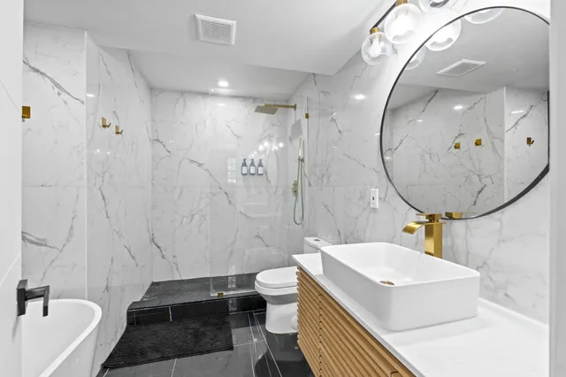 a bathroom with a sink a toilet and tub