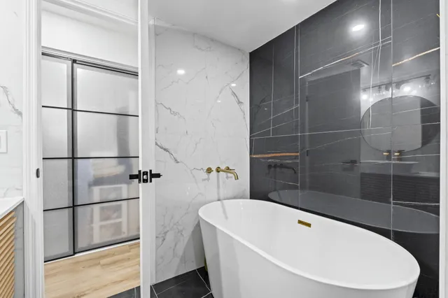 a bathroom with a bathtub and shower