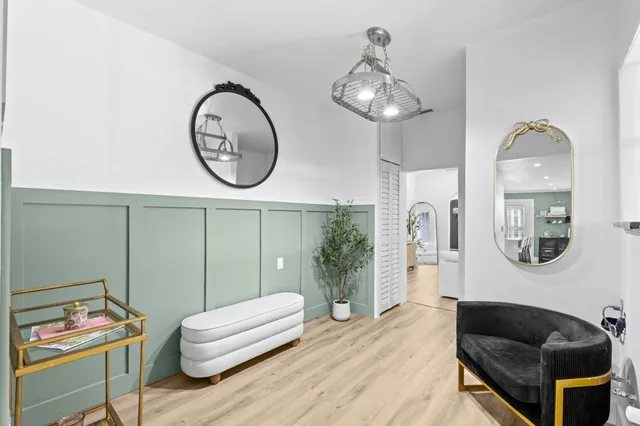 a living room with furniture a mirror and a window