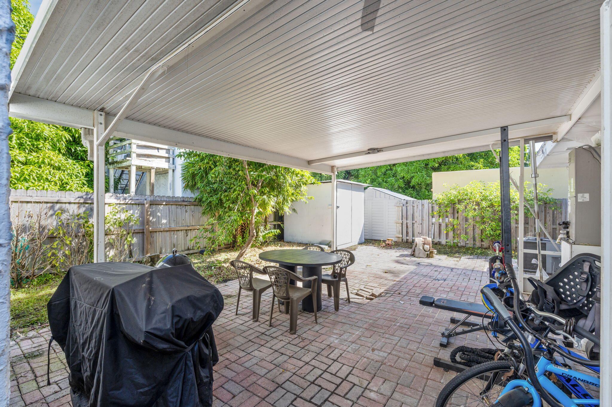715 Kaye Street West Palm Beach, FL 33405 - Photo 35 of 40 a view of a patio with table and chairs and floor to ceiling window