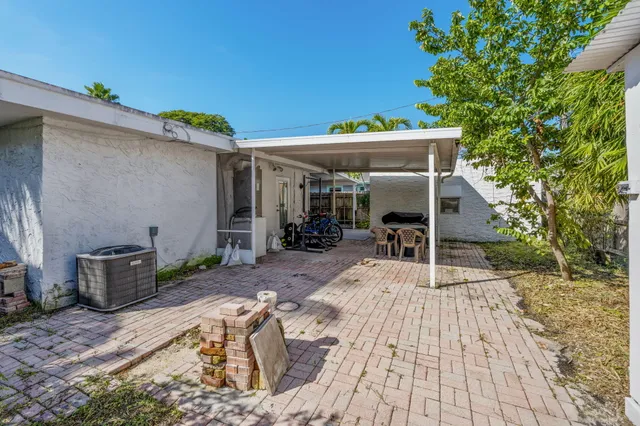 a view of a patio with table and chairs with wooden floor and fence