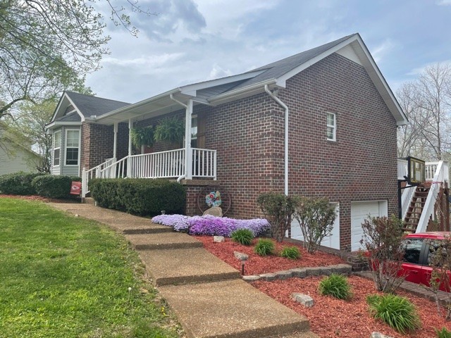 7532 Cherokee Hills Road Fairview, TN 37062 - Photo 1 of 14 a front view of a house with garden