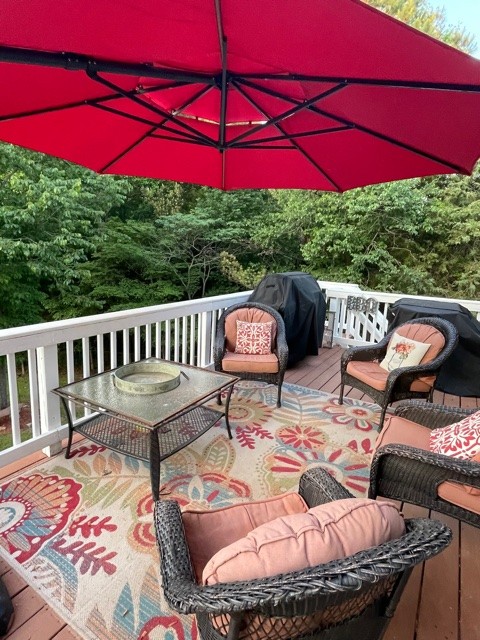 7532 Cherokee Hills Road Fairview, TN 37062 - Photo 4 of 14 a view of a patio with couches chairs under an umbrella