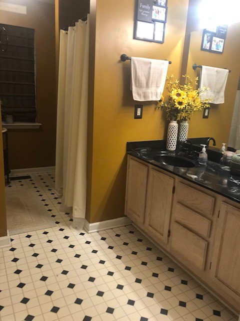 7532 Cherokee Hills Road Fairview, TN 37062 - Photo 9 of 14 a bathroom with a sink a mirror and a shower
