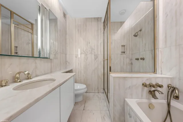 a bathroom with a sink a toilet and bathtub