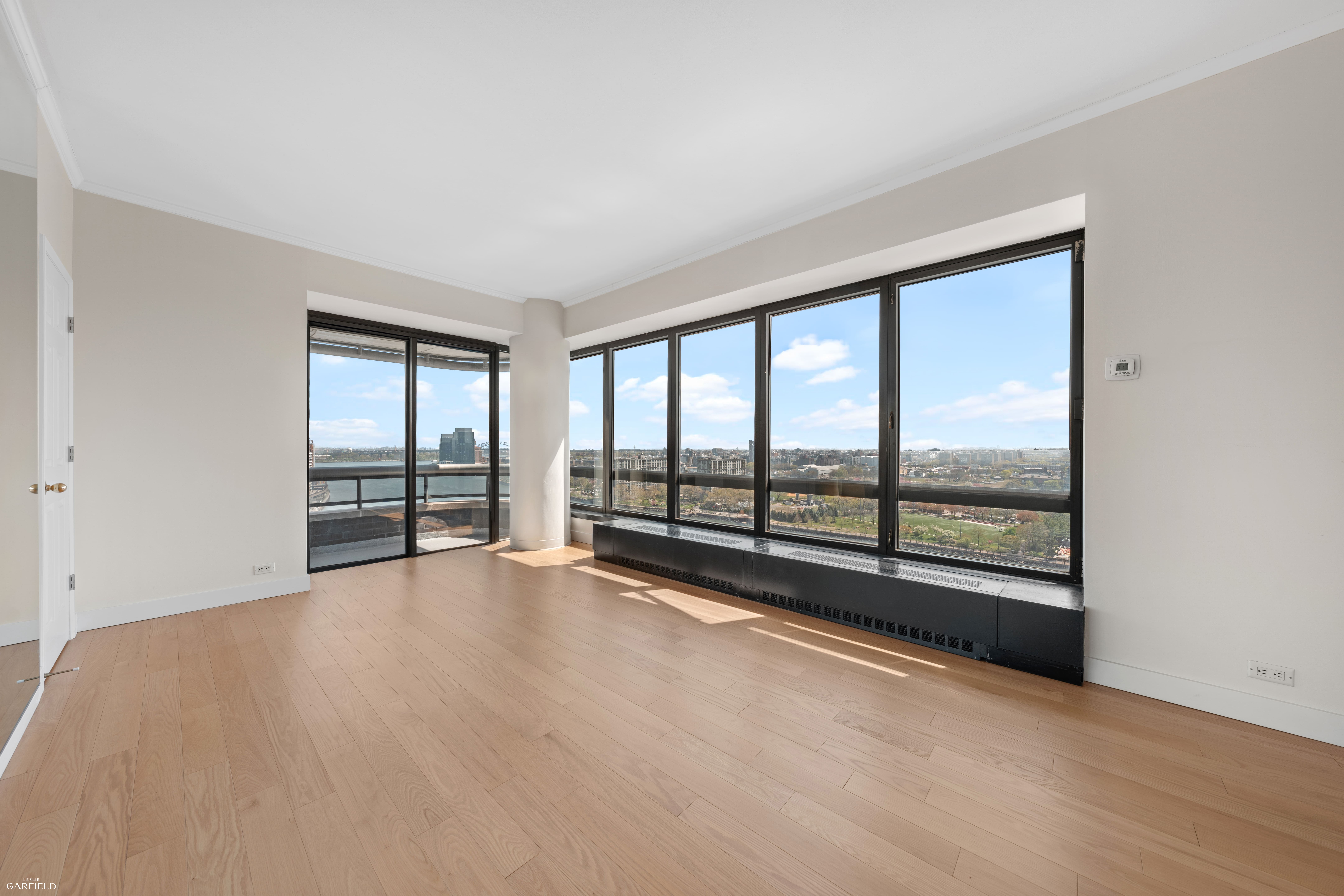 530 East 76th Street, Unit 18G Manhattan, NY 10021 - Photo 3 of 16 wooden floor and windows in an empty room
