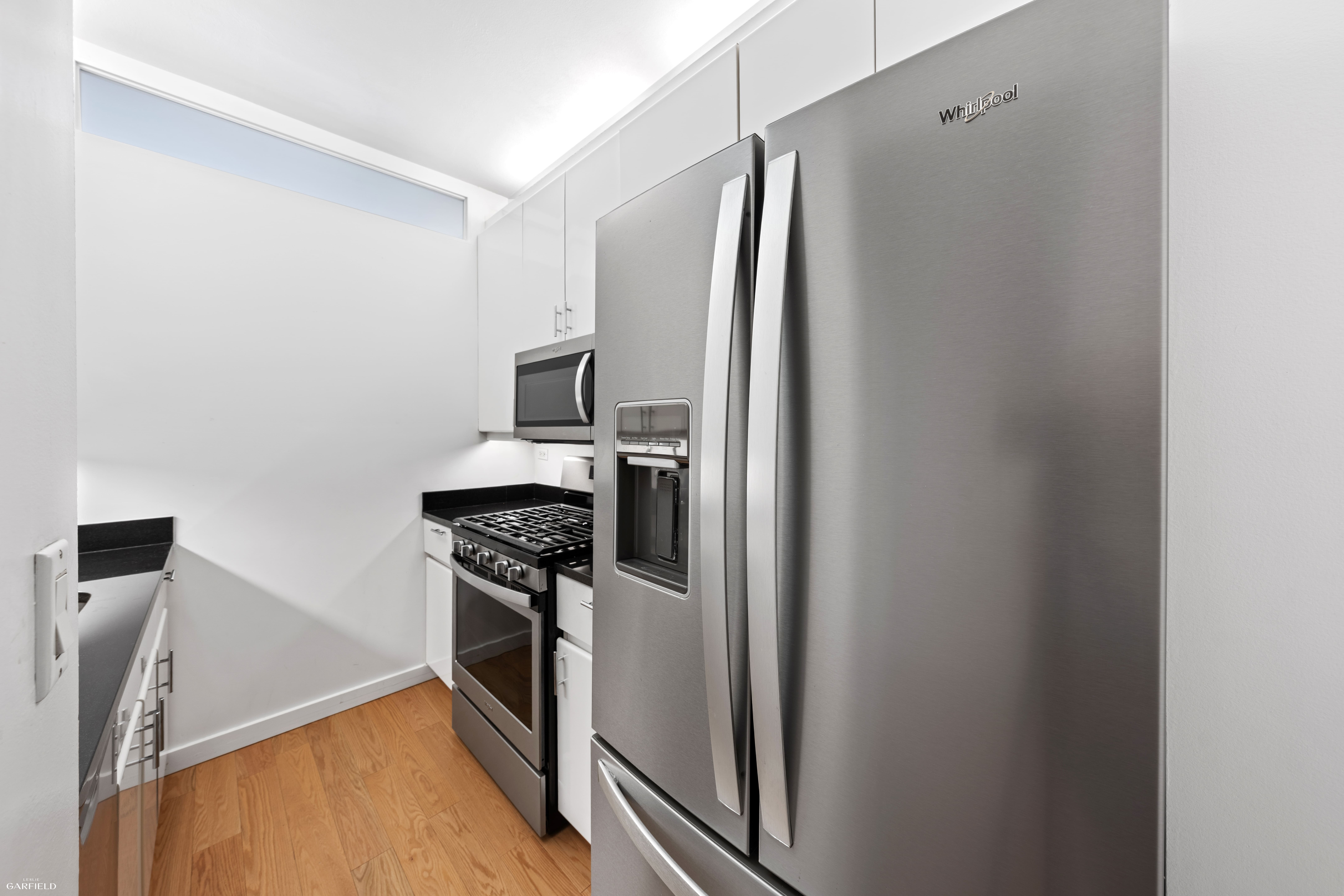 530 East 76th Street, Unit 18G Manhattan, NY 10021 - Photo 6 of 16 a kitchen with stainless steel appliances granite countertop a refrigerator and a stove