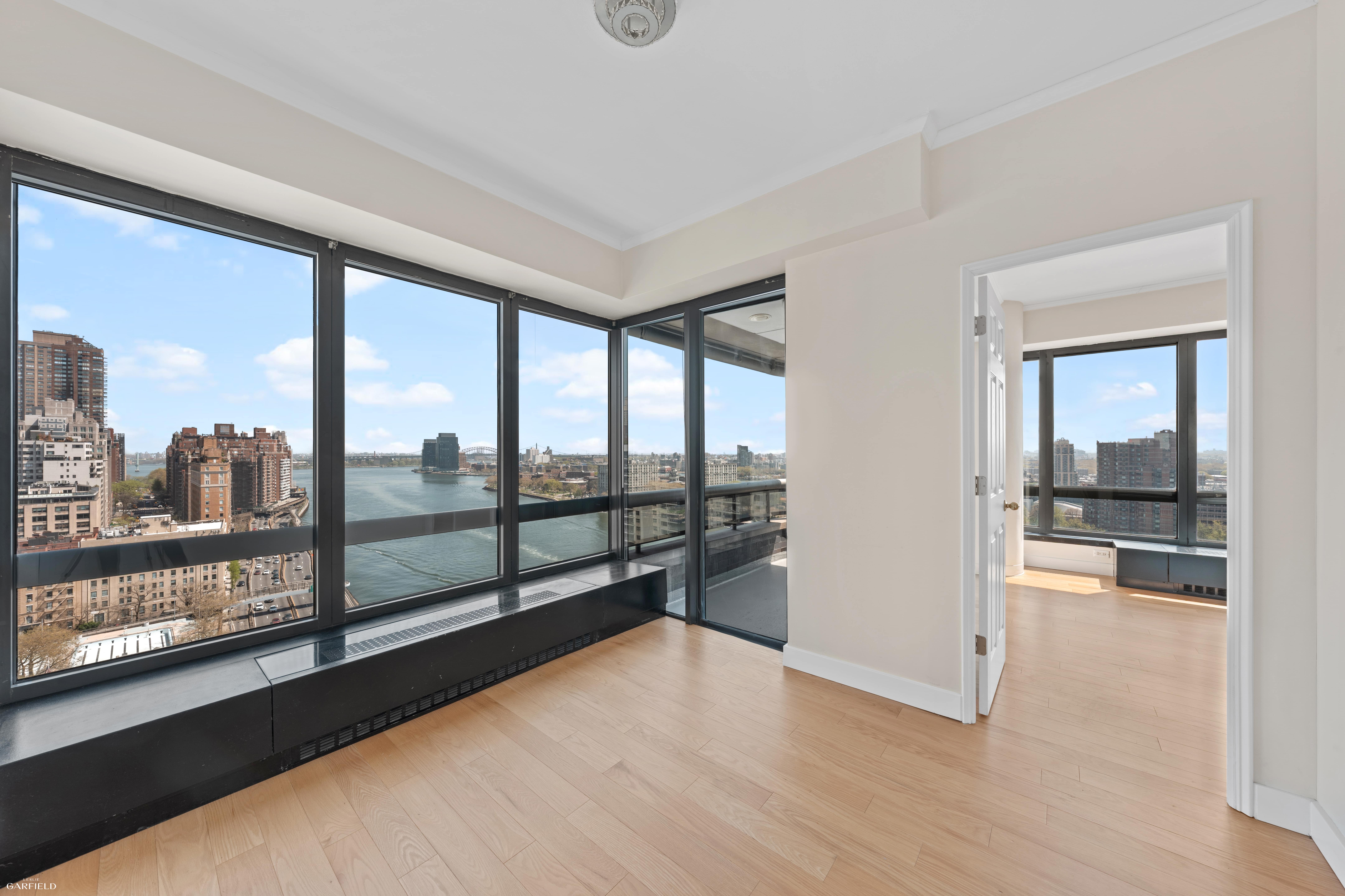 530 East 76th Street, Unit 18G Manhattan, NY 10021 - Photo 7 of 16 a view of a living room hardwood floor and a large window