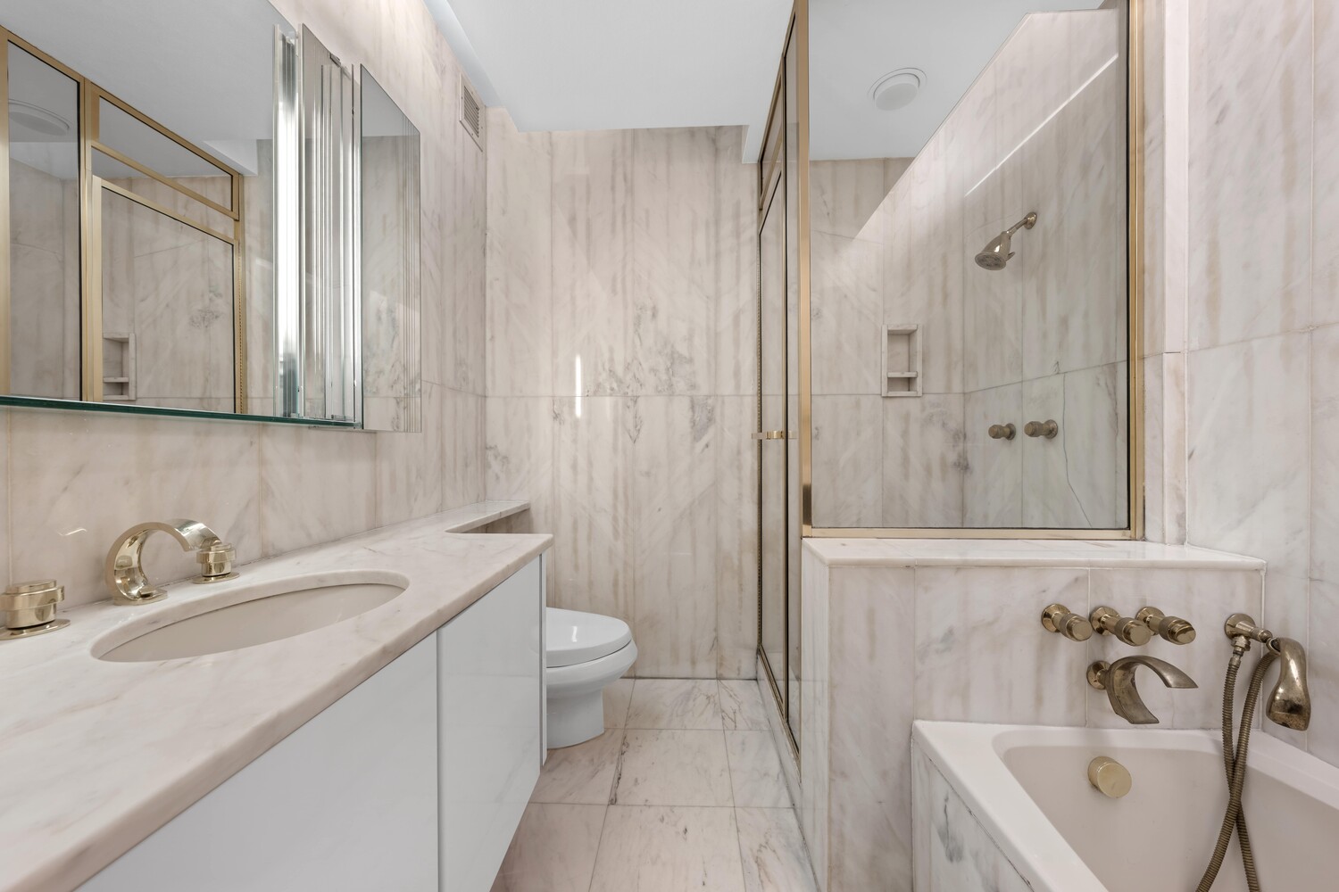 530 East 76th Street, Unit 18G Manhattan, NY 10021 - Photo 7 of 12 a bathroom with a sink a toilet and bathtub