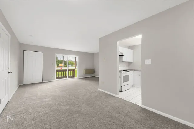 an empty room with windows and entrance