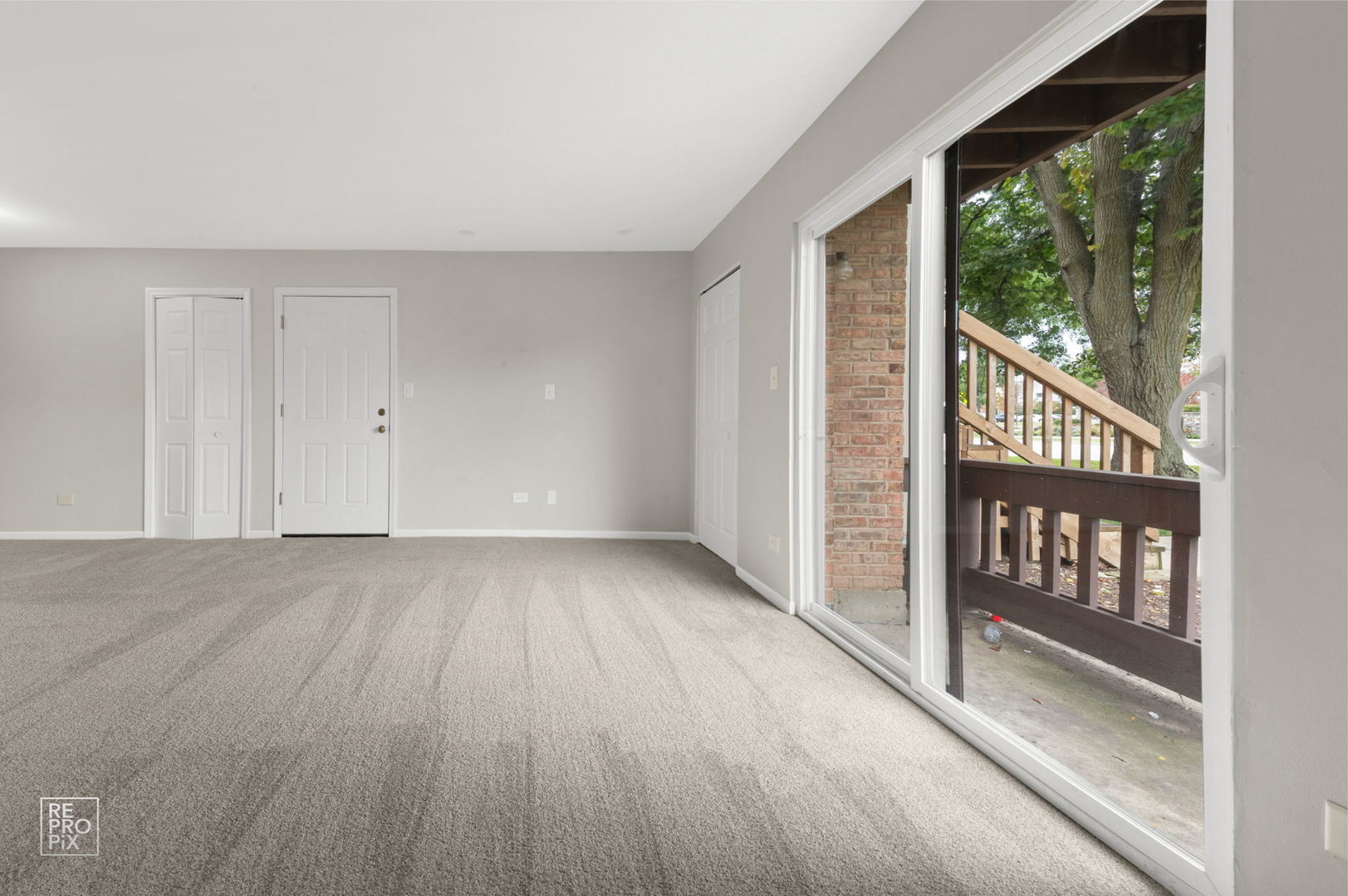 271 Northgate Parkway, Unit 1B Wheeling, IL 60090 - Photo 5 of 10 a view of an empty room with wooden floor and windows