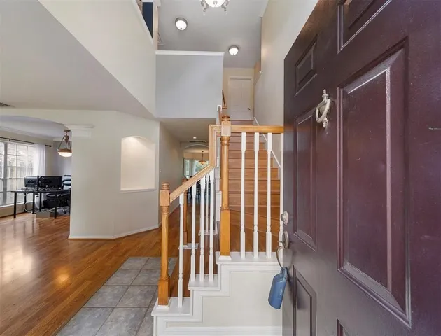 a view of entryway and hall with wooden floor