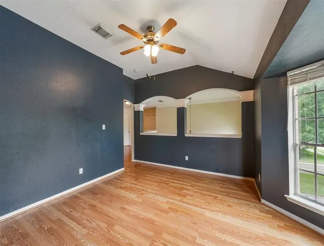 a view of a livingroom with a ceiling fan and window