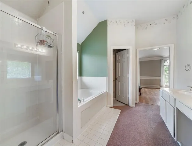 a bathroom with a bathtub and a shower