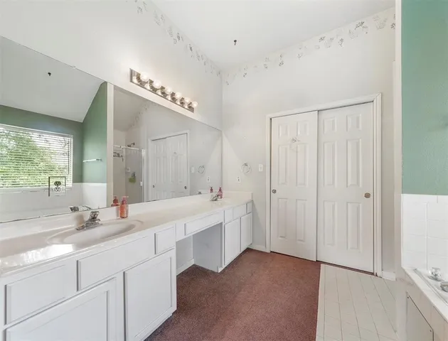 a bathroom with a double vanity sink mirror and double