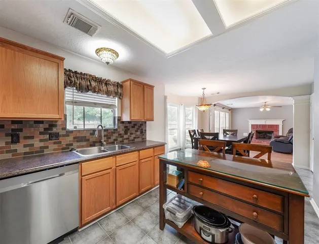 a kitchen with a sink stove and cabinets