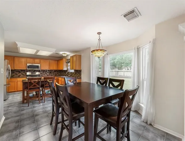 a view of a dining room with furniture and window