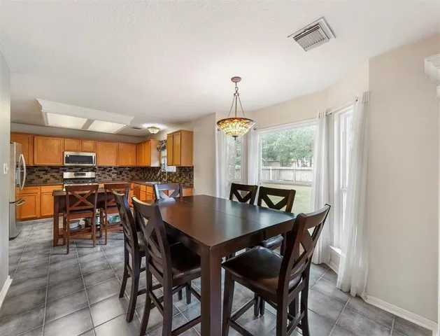 a view of a dining room with furniture and window