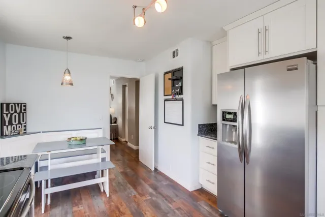 a kitchen with a refrigerator and cabinets
