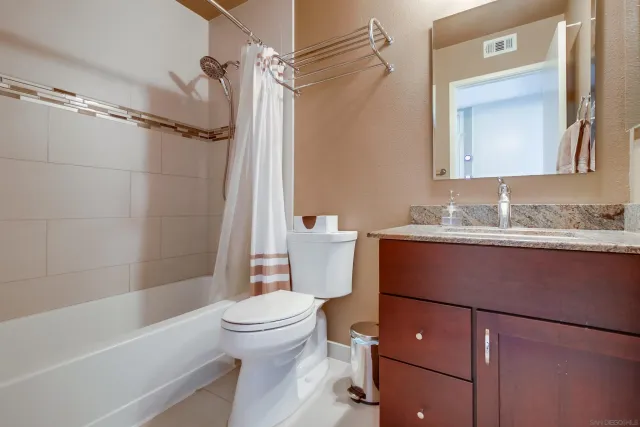 a bathroom with a sink toilet vanity and shower