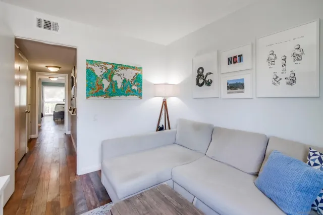 a living room with furniture and a wooden floor