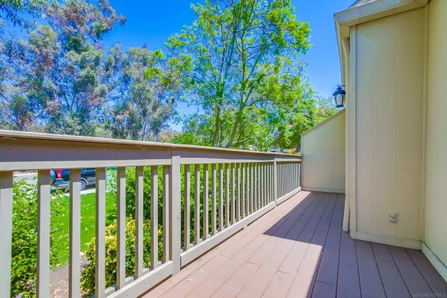 a view of a balcony with wooden floor