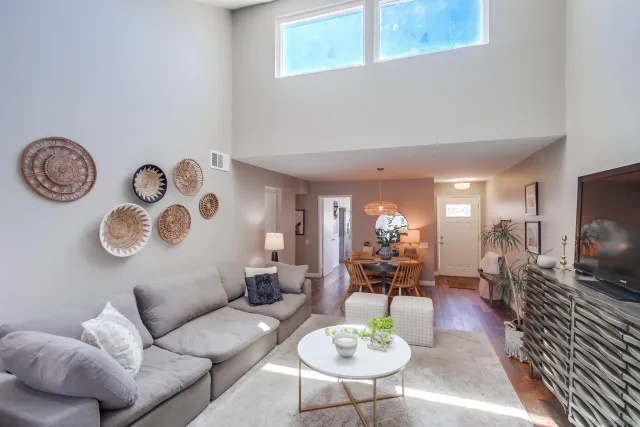 a living room with furniture a rug and wall painting