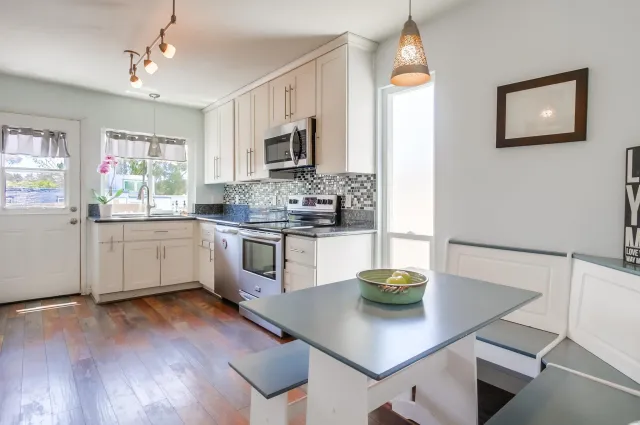 a kitchen with a sink cabinets and wooden floor