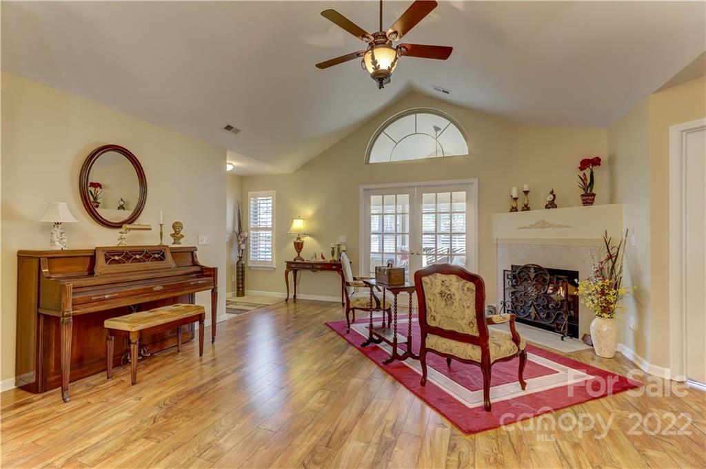 728 Ledgestone Court Tega Cay, SC 29708 - Photo 13 of 30 a living room with furniture a piano and a fireplace