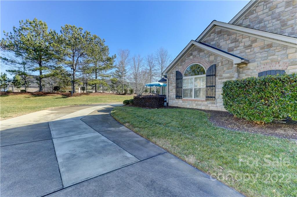 728 Ledgestone Court Tega Cay, SC 29708 - Photo 25 of 30 a view of a white house with a big yard and large trees
