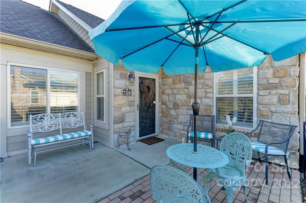 728 Ledgestone Court Tega Cay, SC 29708 - Photo 28 of 30 a patio with a table and chairs under an umbrella