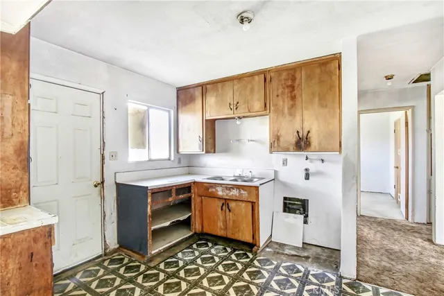 a kitchen with granite countertop cabinets and window