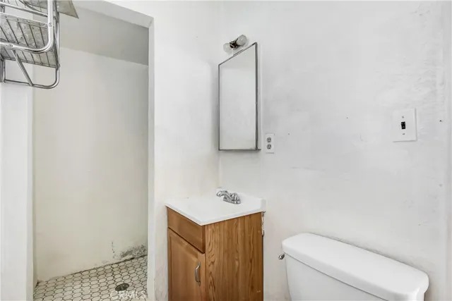 a bathroom with a toilet a sink and mirror