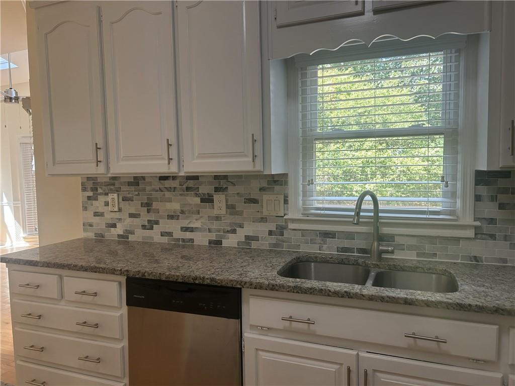 1273 Channel Park Southwest Marietta, GA 30064 - Photo 7 of 69 a kitchen with granite countertop a sink window and cabinets