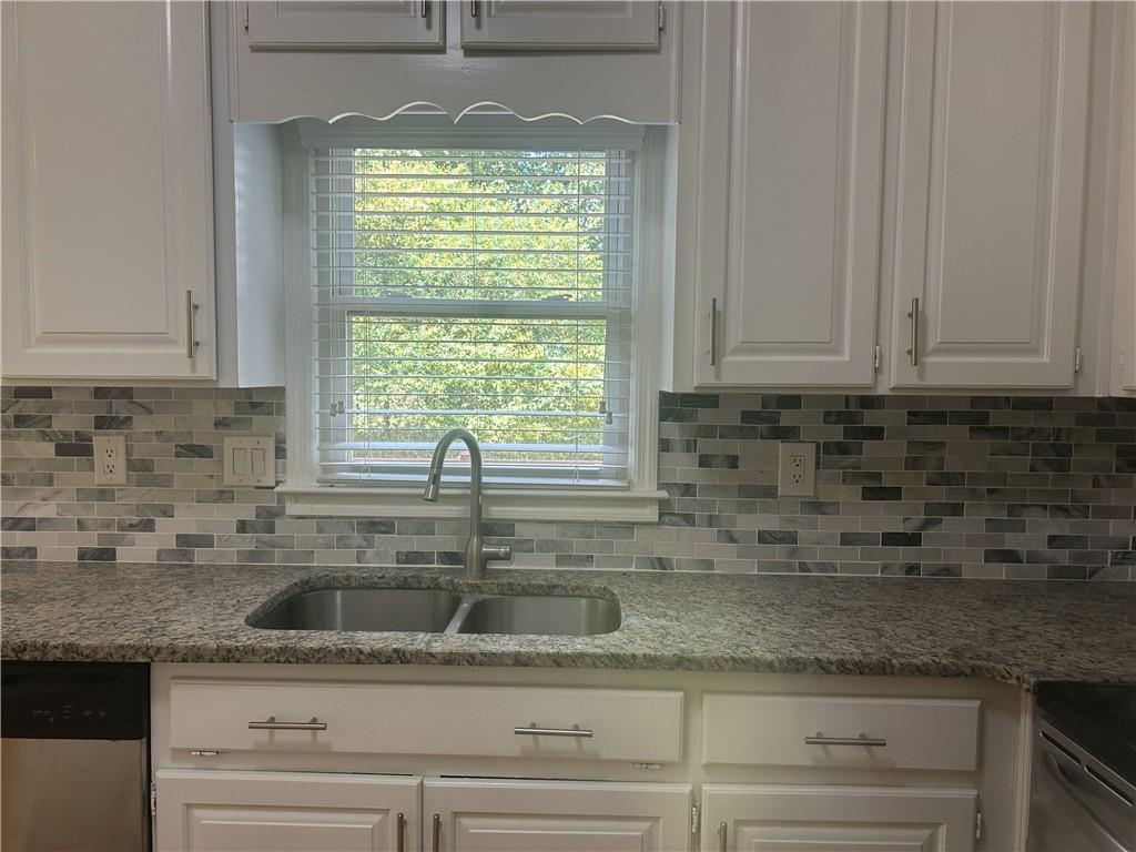 1273 Channel Park Southwest Marietta, GA 30064 - Photo 8 of 69 a kitchen with granite countertop a sink stainless steel appliances white cabinets and a window