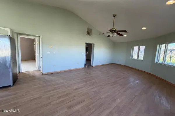 a view of empty room with ceiling fan
