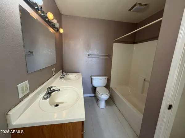 a bathroom with a sink and mirror with toilet
