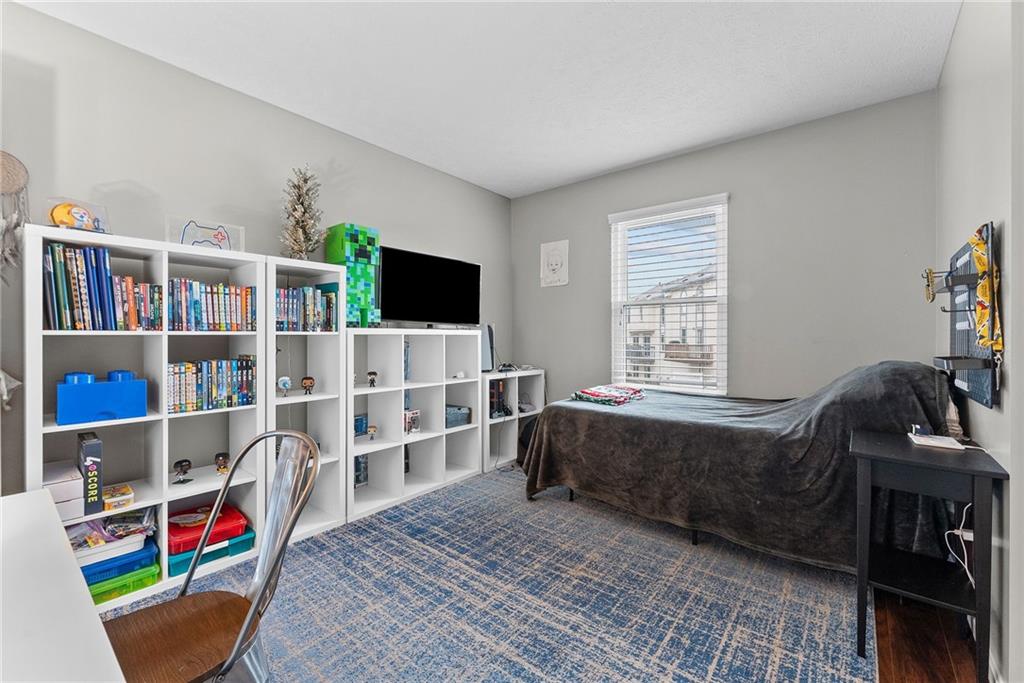 1163 Valleyview Drive Lawrence, PA 15055 - Photo 17 of 25 a living room with furniture a flat screen tv and a book shelf