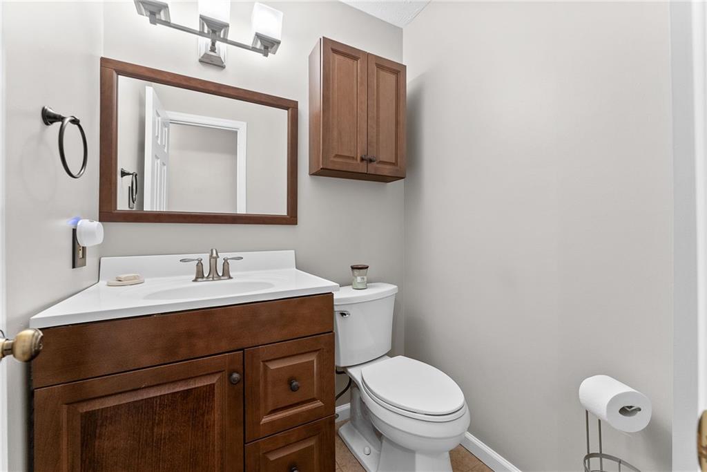 1163 Valleyview Drive Lawrence, PA 15055 - Photo 10 of 25 a bathroom with a toilet sink vanity and mirror