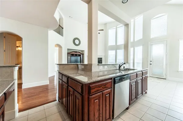 a kitchen with stainless steel appliances granite countertop a stove and a sink