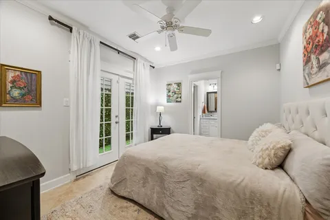 a bedroom with a large bed and a chandelier
