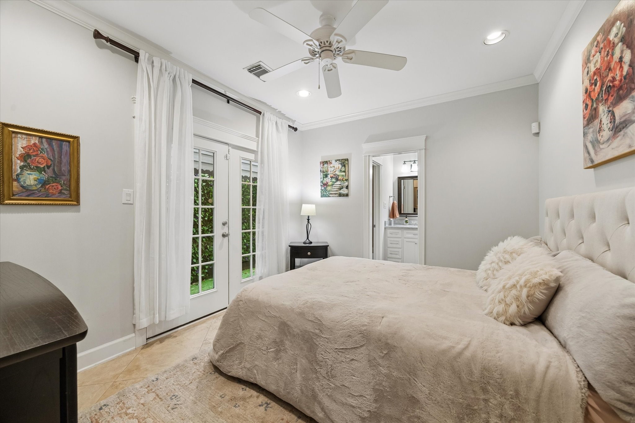 609 Rutland Street, Unit A Houston, TX 77007 - Photo 26 of 30 a bedroom with a large bed and a chandelier