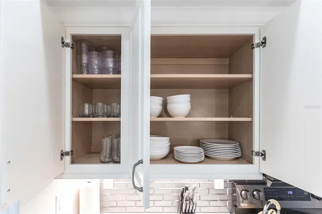 a shelf with books and knick knacks on it