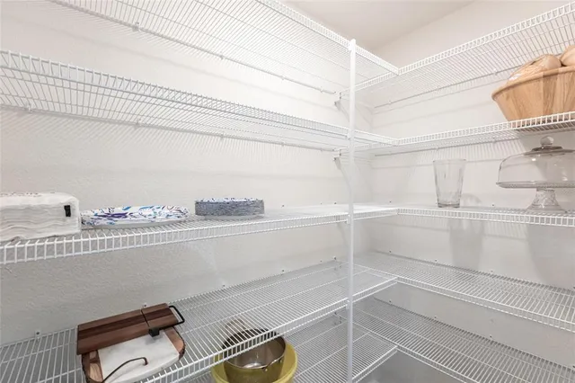 a view of a closet with racks on the wall